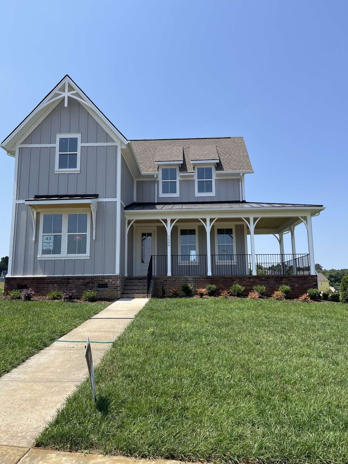 Such an inviting wrap around front porch, and charming architectural details!