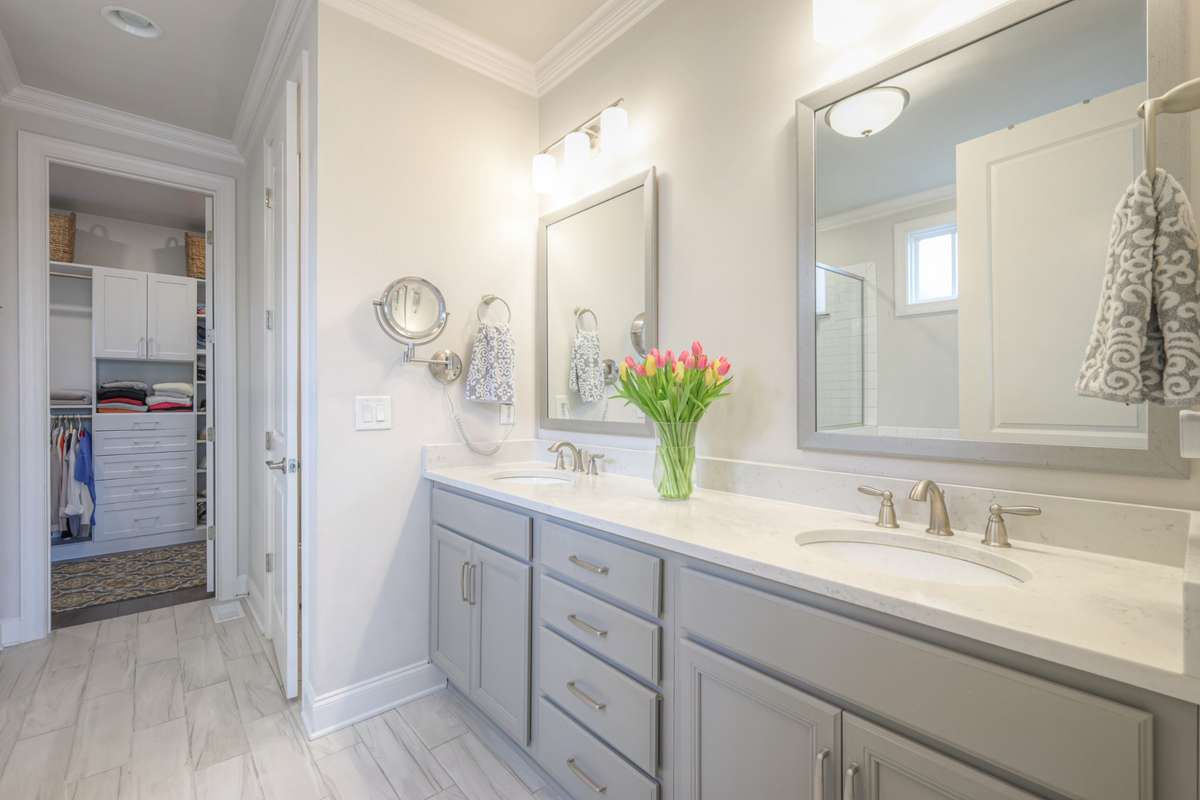Gorgeous primary bathroom with walk-in closet with built in storage
