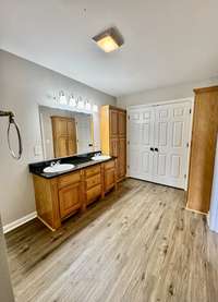 great en suite bath with double vanities and plenty of cabinet storage