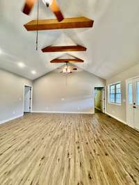 Beautiful great room with cathedral ceilings and wood beams