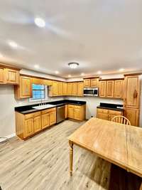 huge kitchen with lots of oak cabinets and granite counters
