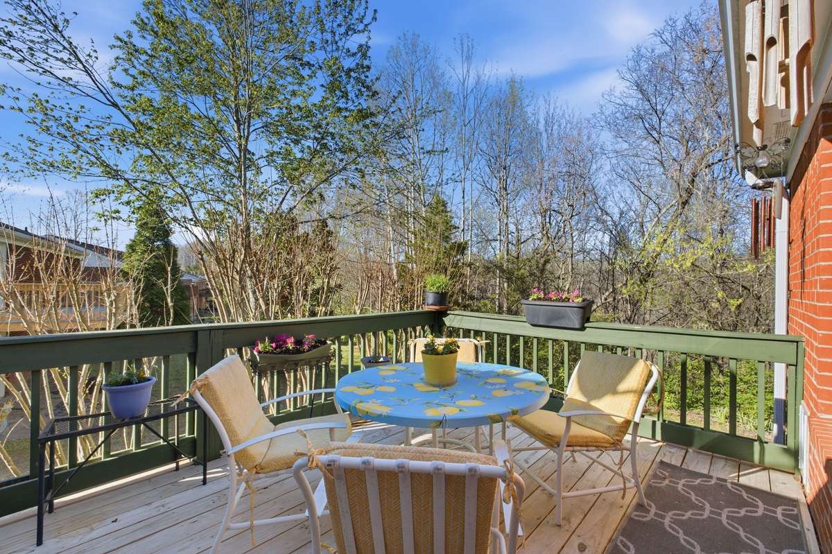 Back deck overlooks a park-like backyard setting