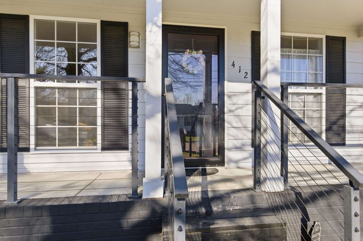 This updated front porch adds to the curb appeal and compliments the well established garden beds in front