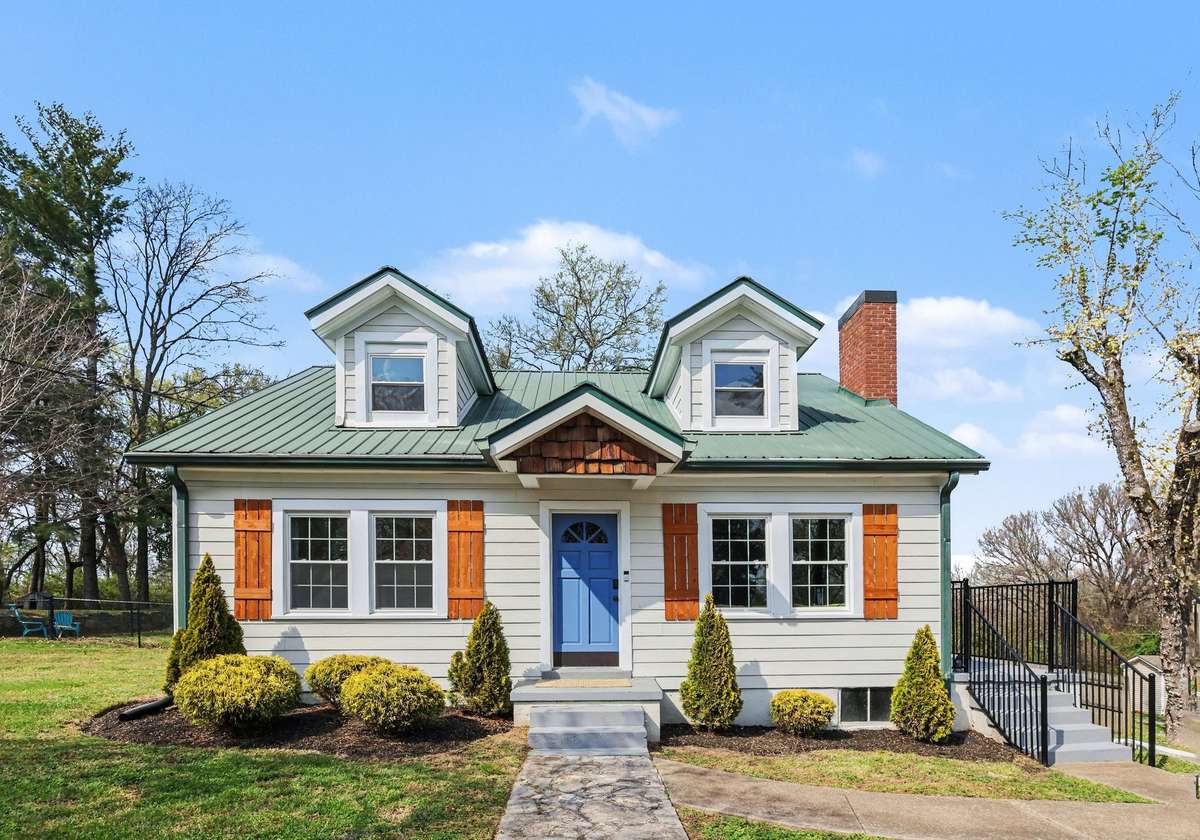 Mature landscaping and wood shutters out front.