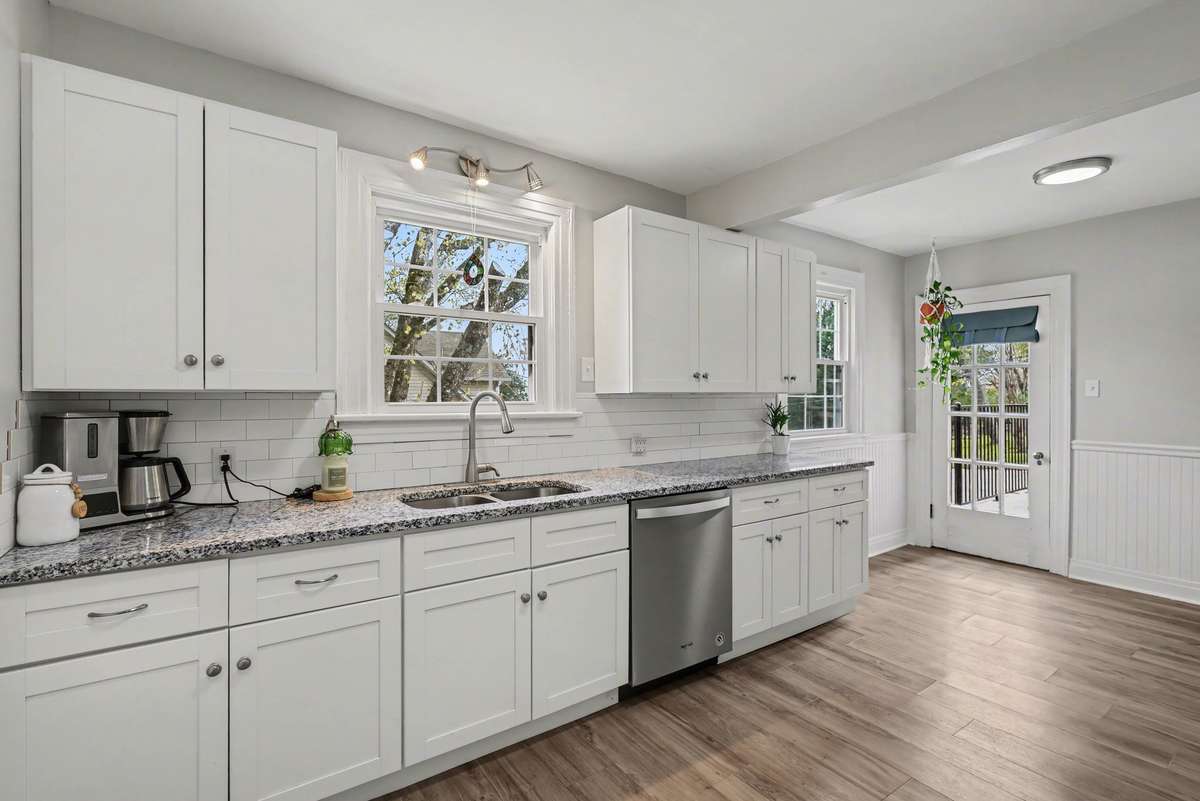 Eat-in kitchen with granite countertops and access to outdoor spaces.