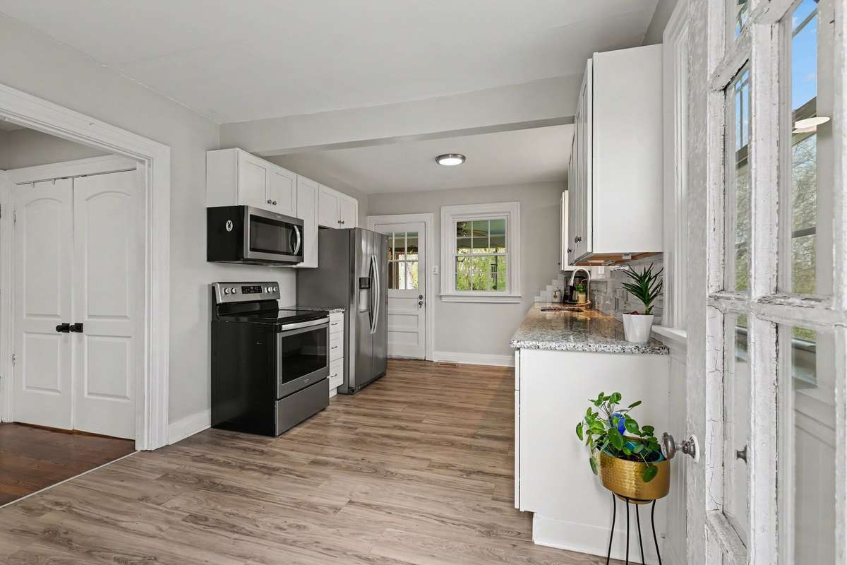 Plenty of natural light and a stylish period back door leading to screened porch out back.
