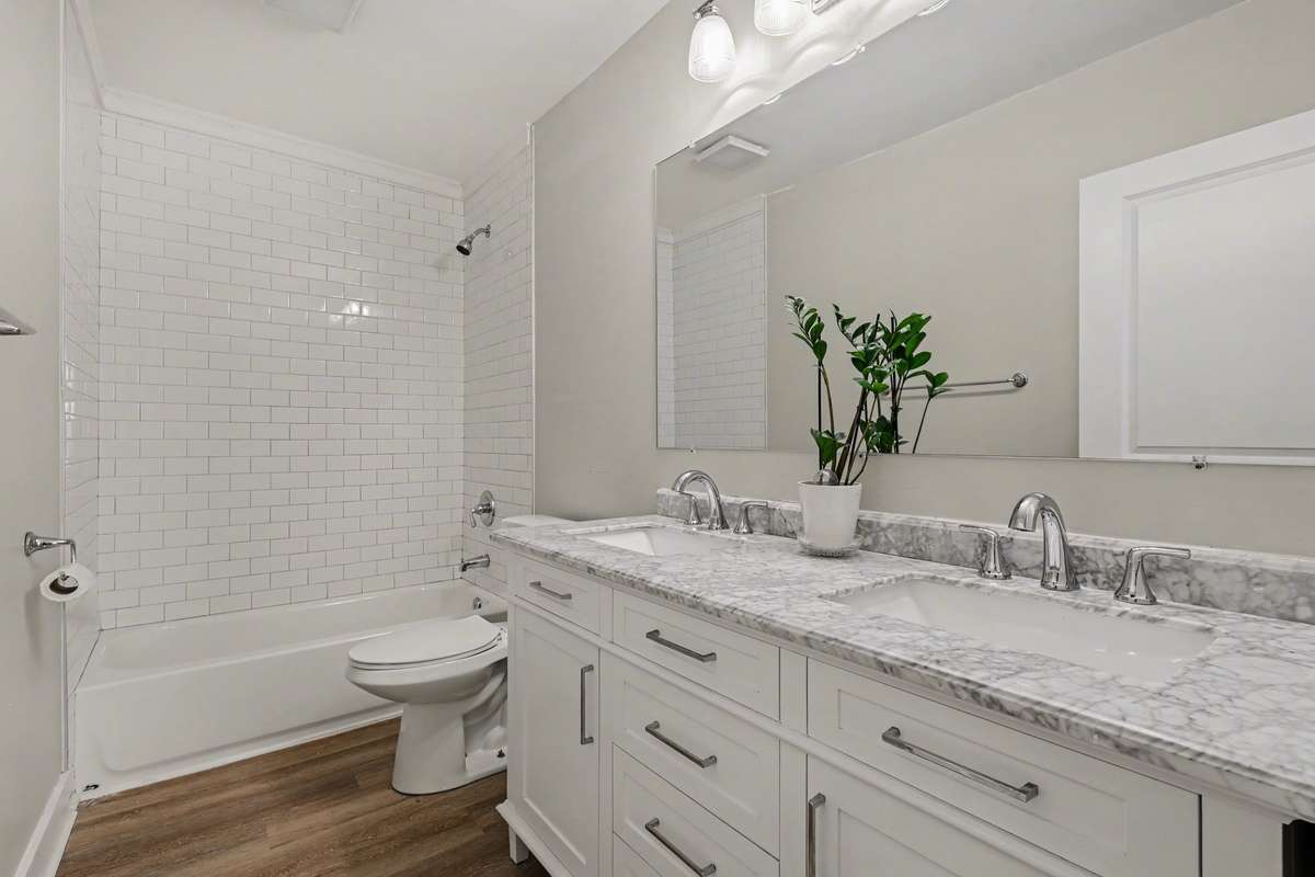 Double vanity with tile shower in primary bath.