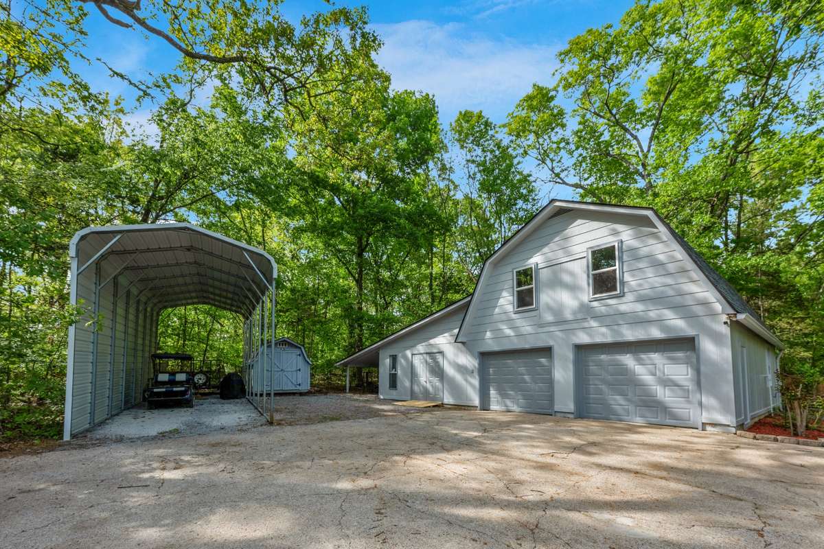 Metal Carport, Wood Shop (heated and cooled) Two car garage