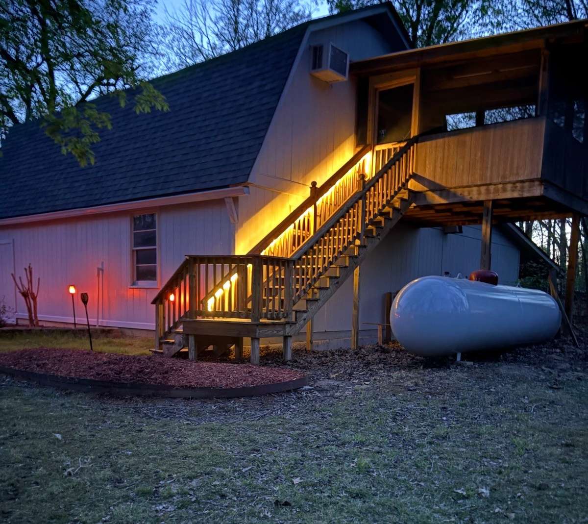 Lighted staircase leading to screened in deck and rec room