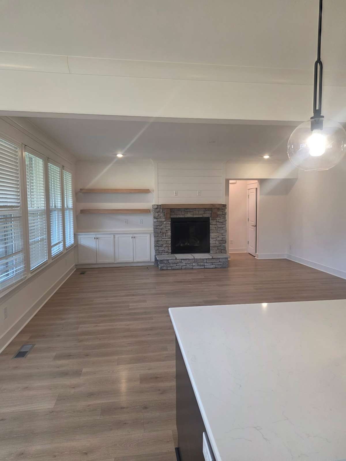 Beautiful Great Room with stone and shiplap gas fireplace and built-ins.
