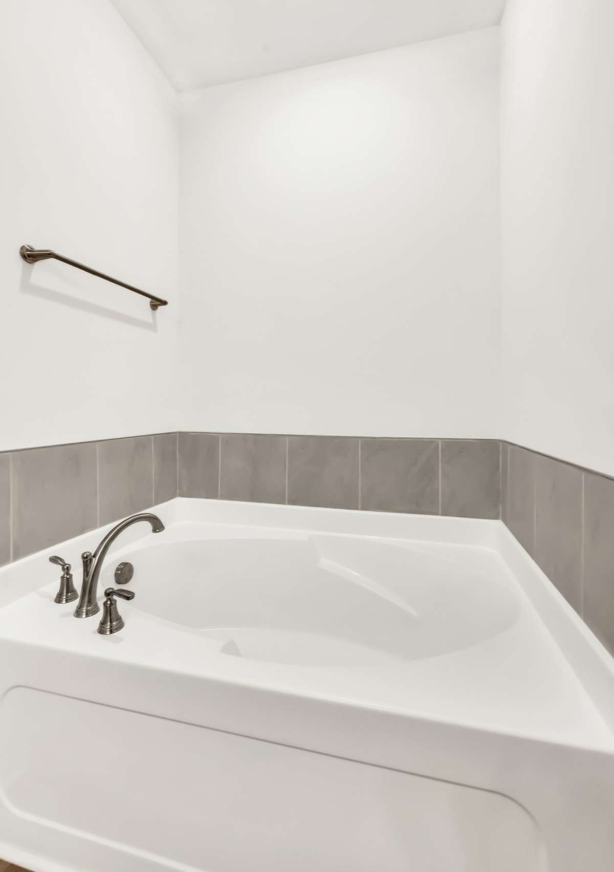 The main bedroom features a stunning bathroom with a generously sized standalone separate shower and oversized soaking tub  both surrounded by tasteful tile accents that add texture and character.