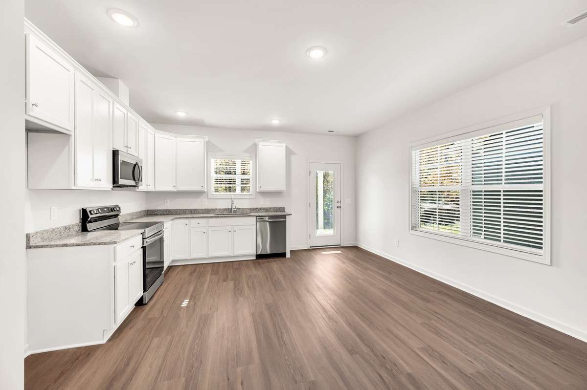 The open-plan design sees the kitchen, living, and dining areas flow seamlessly out to an alfresco entertaining space, creating an easy indoor–outdoor lifestyle perfect for gatherings or relaxed weeknights at home.