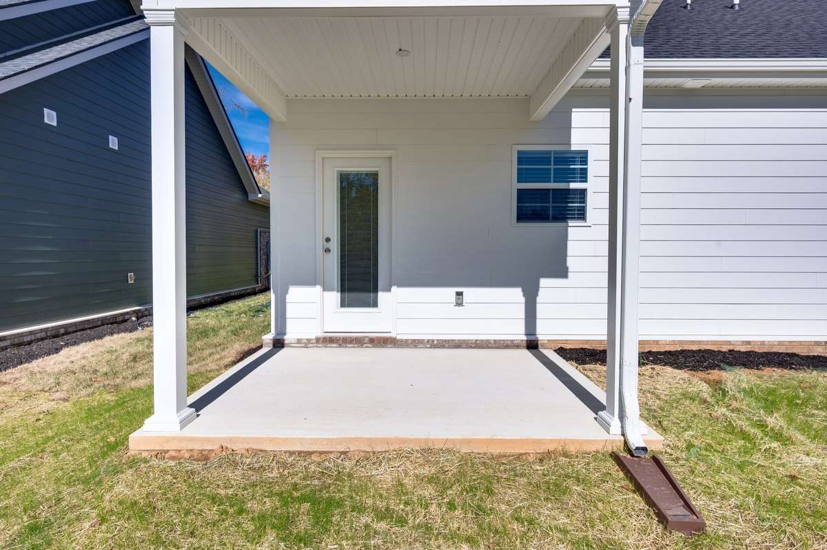 Enjoy your covered back porch—ideal for morning coffee, afternoon reading, or greeting neighbors in style. A private, shaded spot that perfectly extends your living space outdoors.