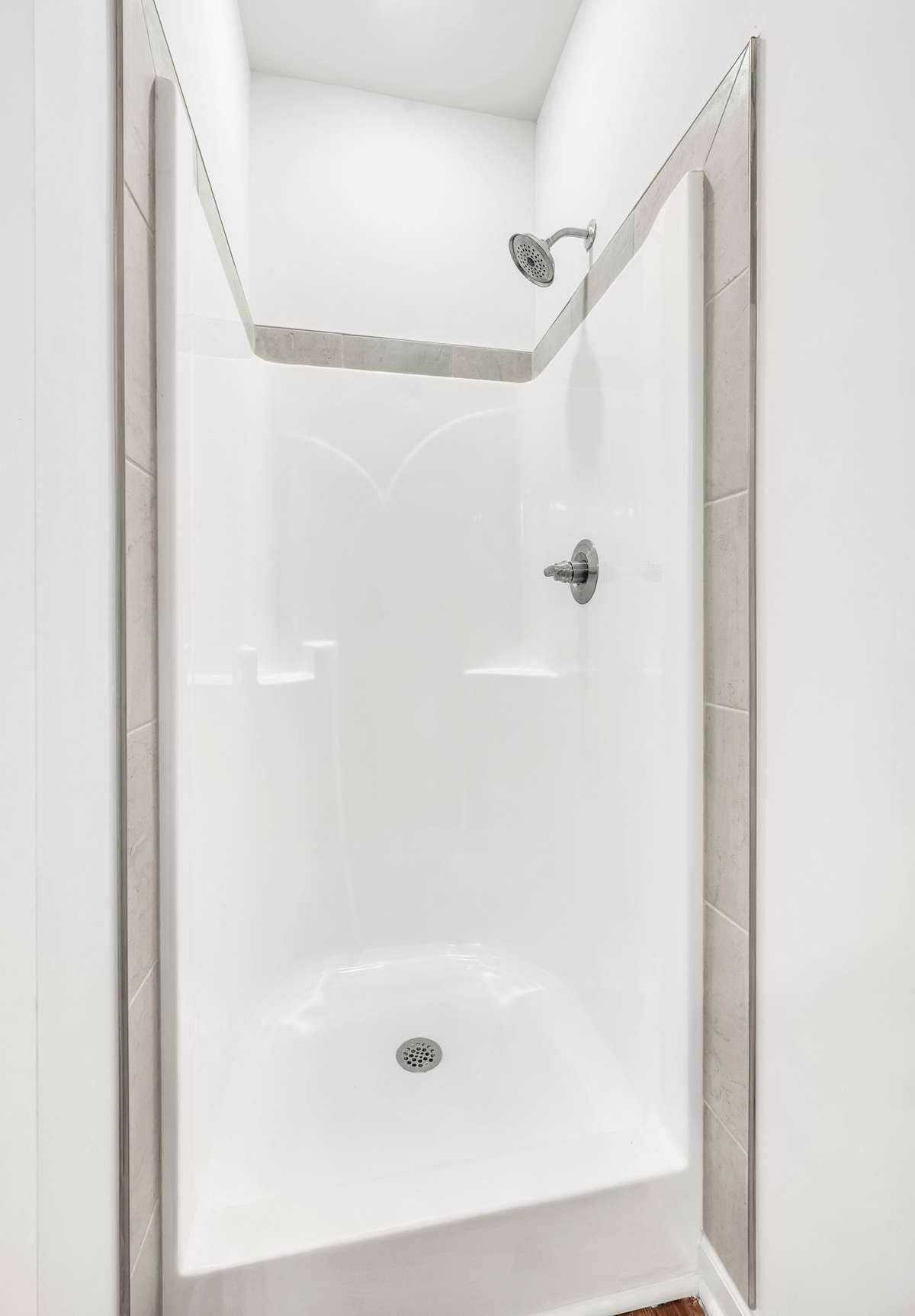 A shower with tile accents completes the space.