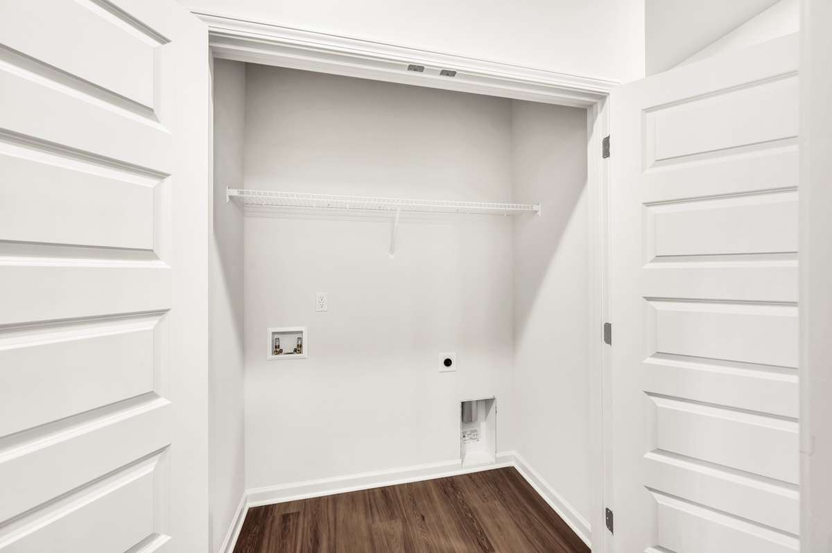 Spacious laundry closet conveniently located near the bedrooms, offering plenty of room for organization — with easy access for a future washer and dryer setup.
