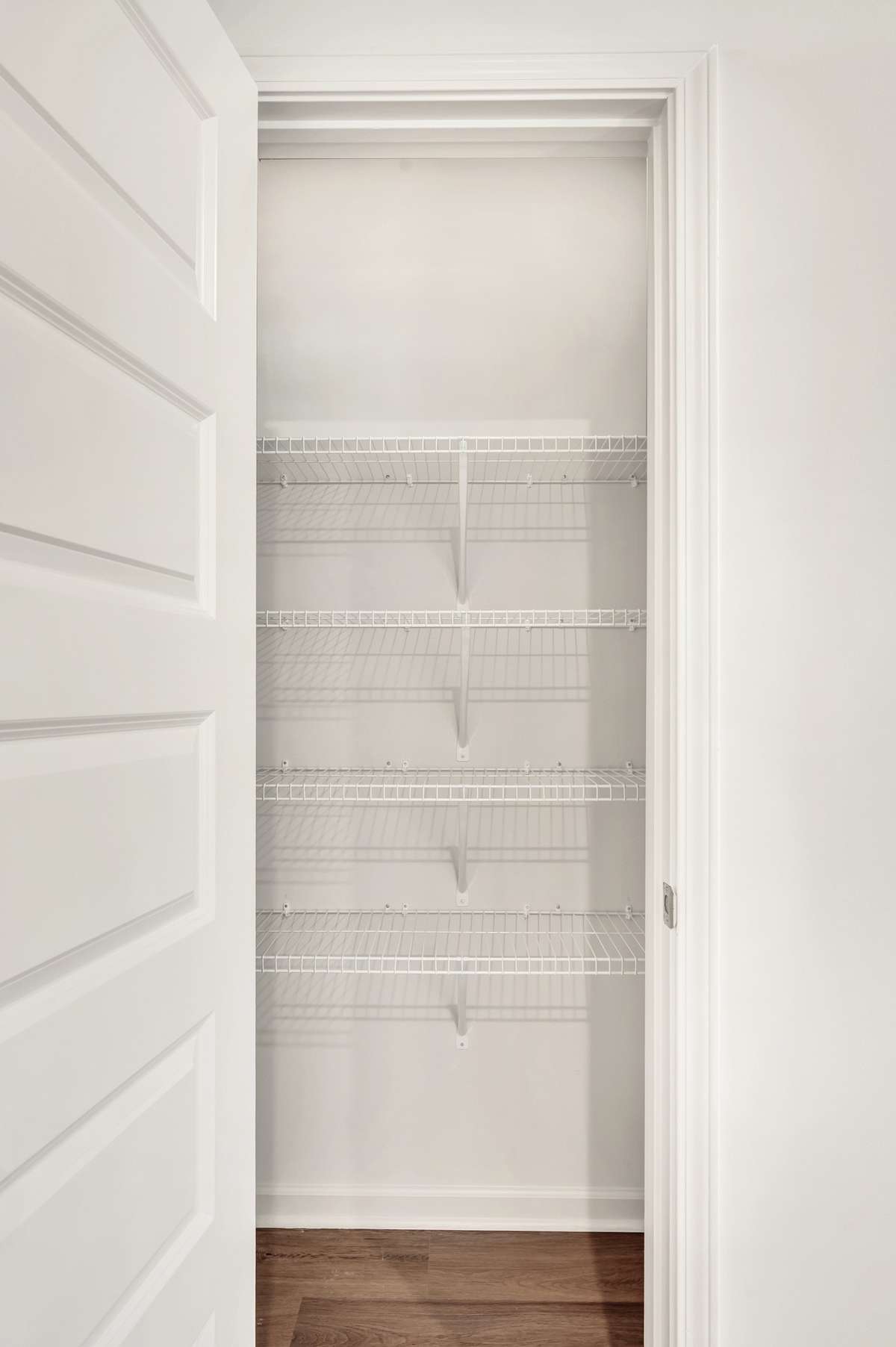 A spacious pantry with plenty of shelves that provides extra storage space.