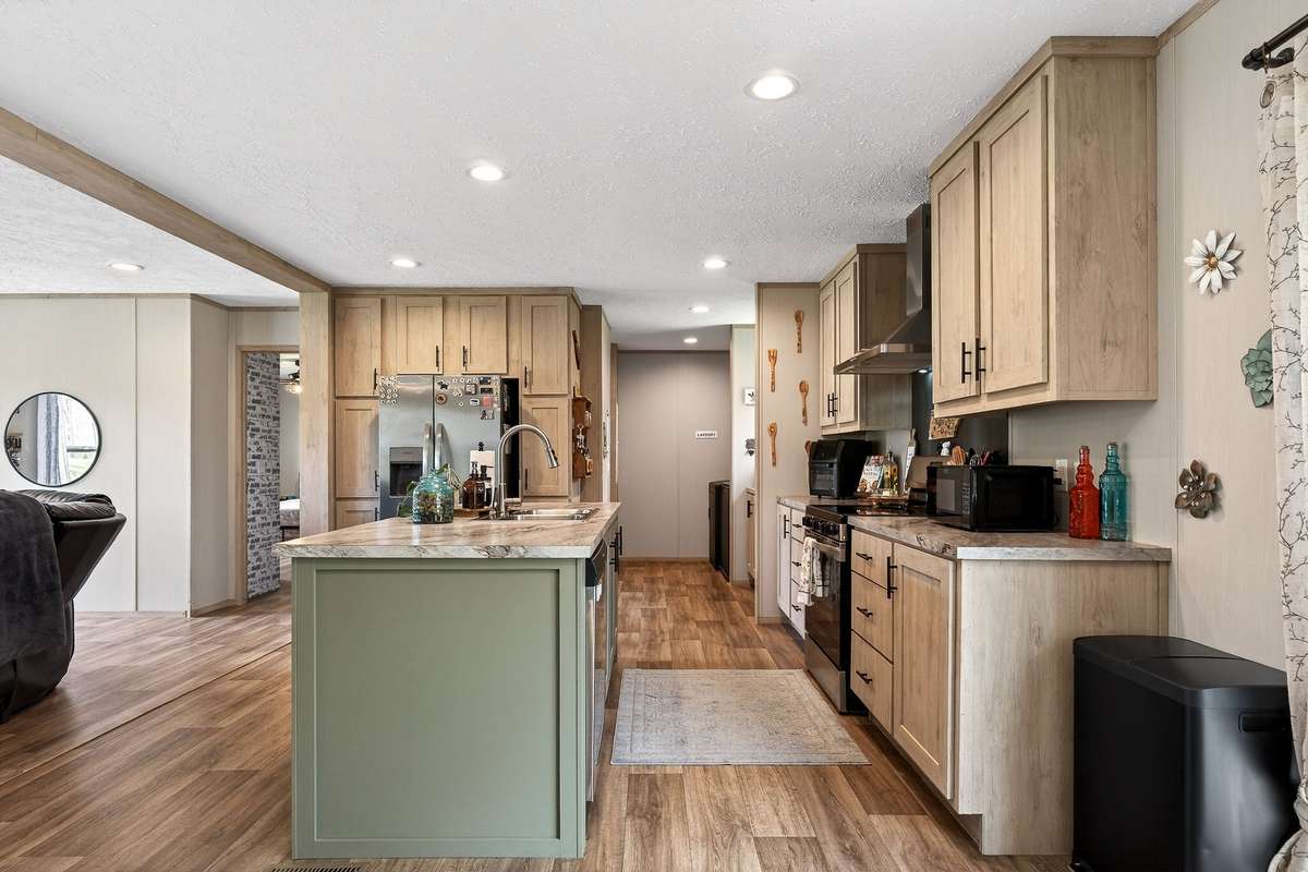 View from dining area into kitchen and into the combination coffee bar/utility room/panty rooms.