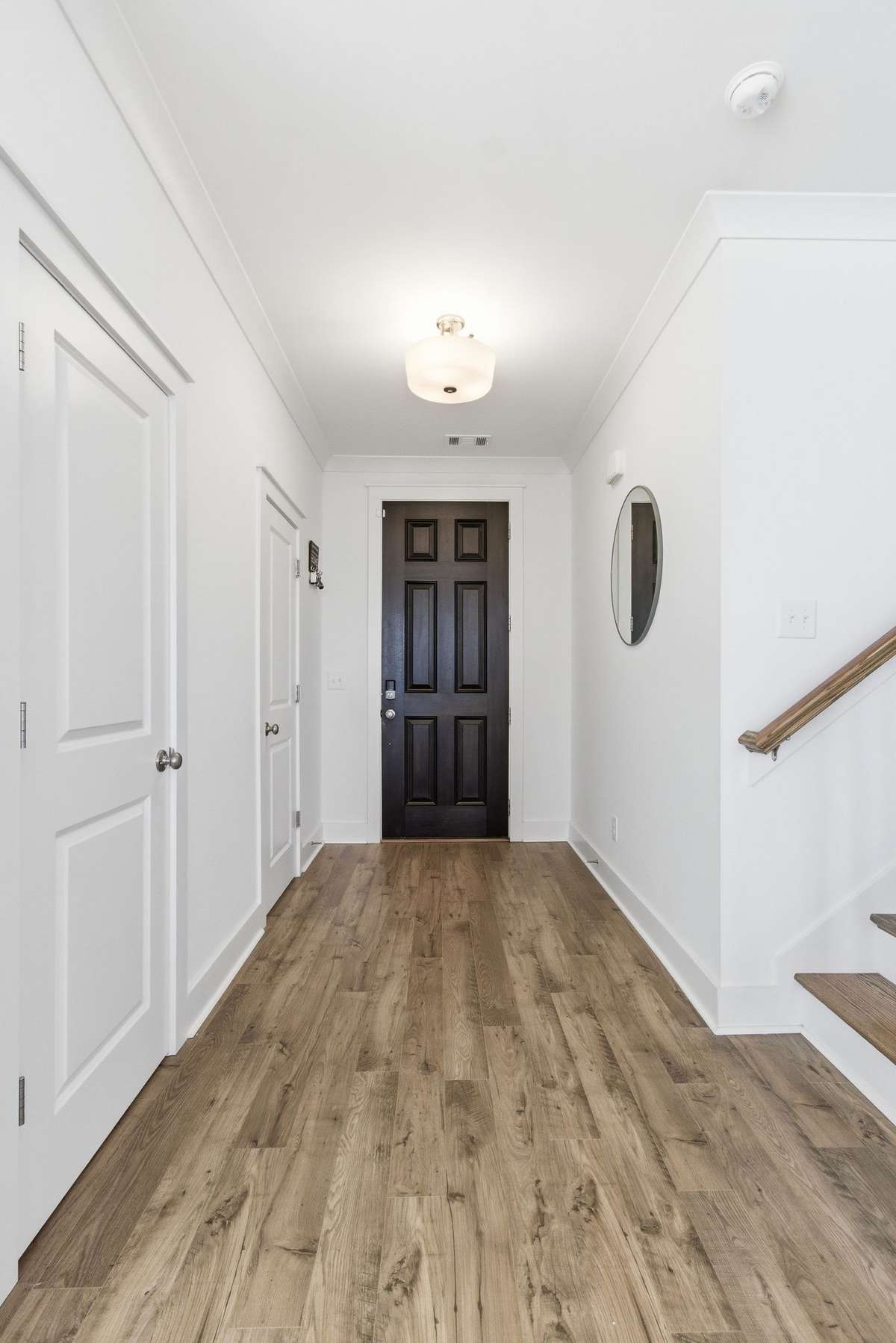 Bright entryway opening into the living space with beautiful hard-surface flooring.
