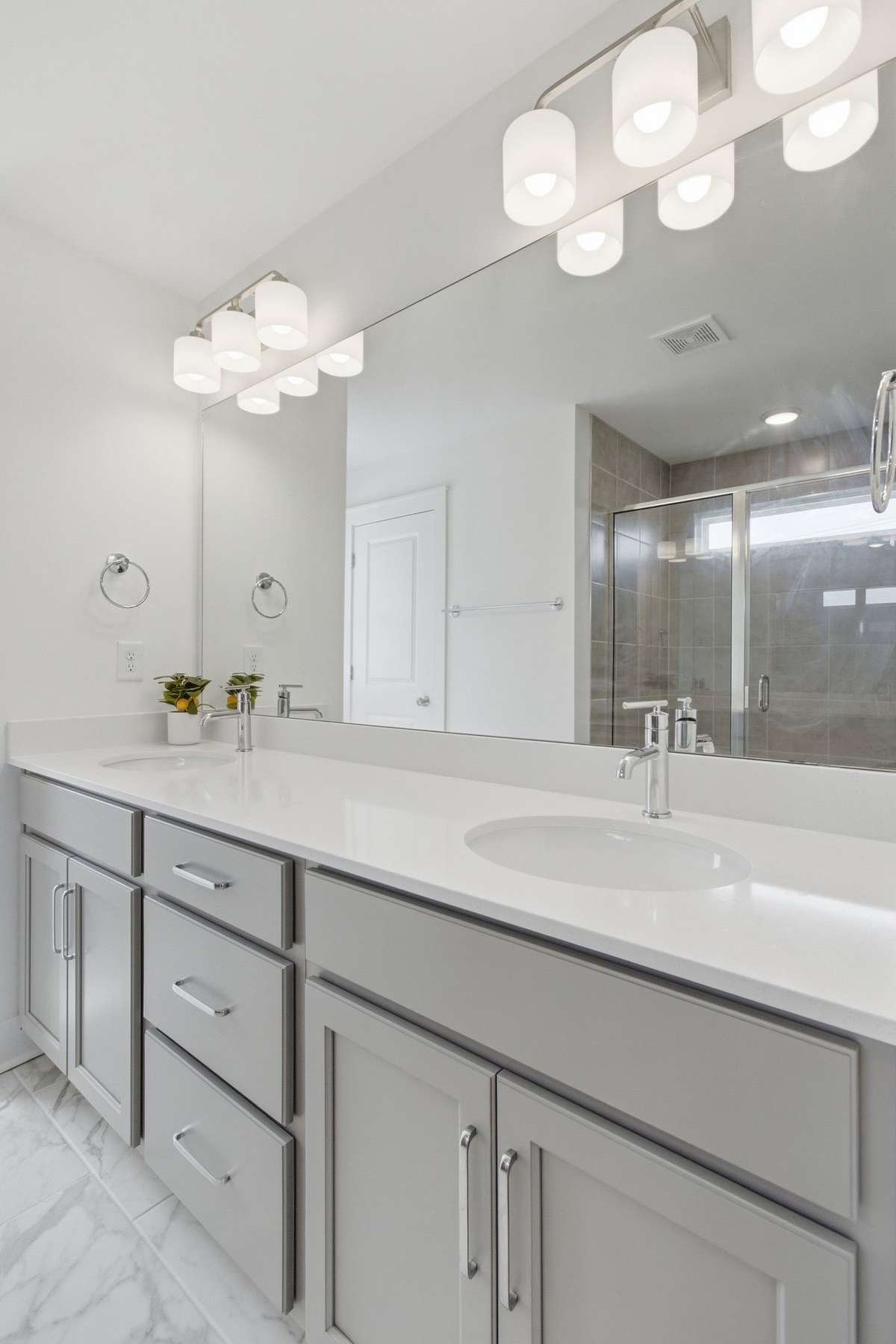 Close-up of the pristine primary bathroom vanity and modern fixtures.
