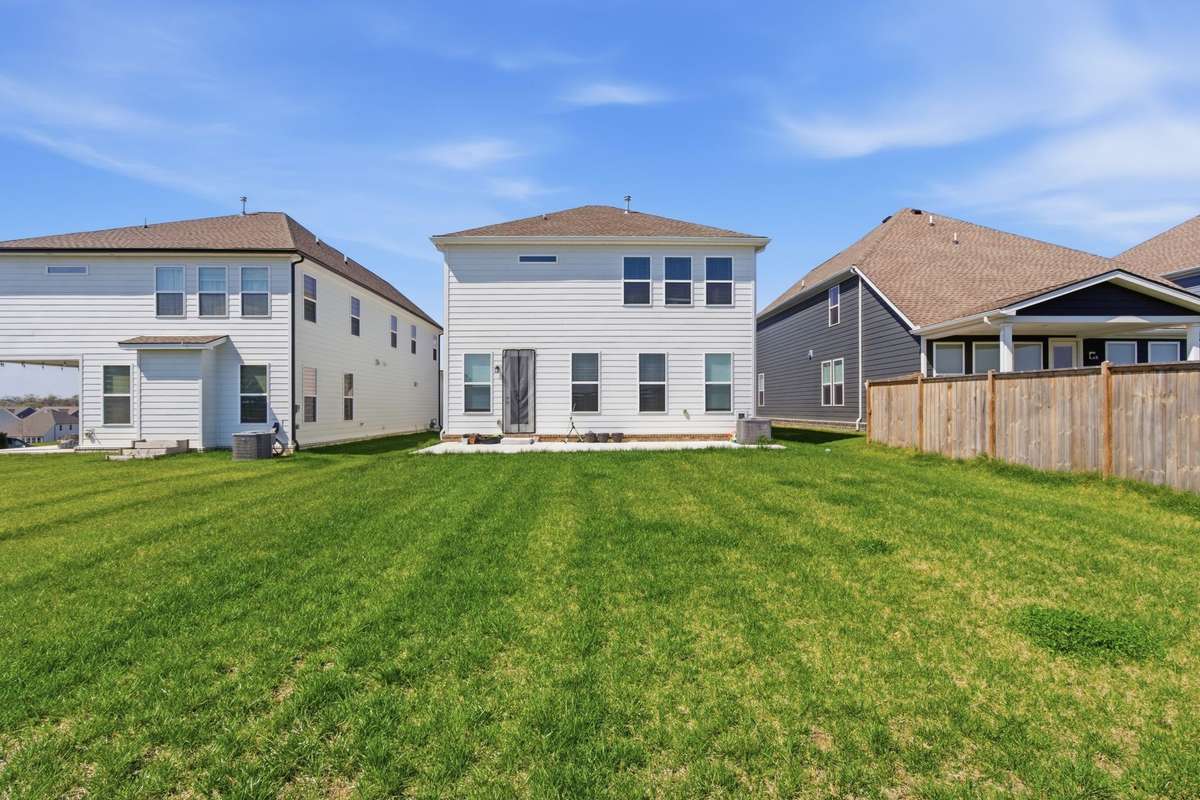 Wide view of the flat, level, and fully sodded backyard.
