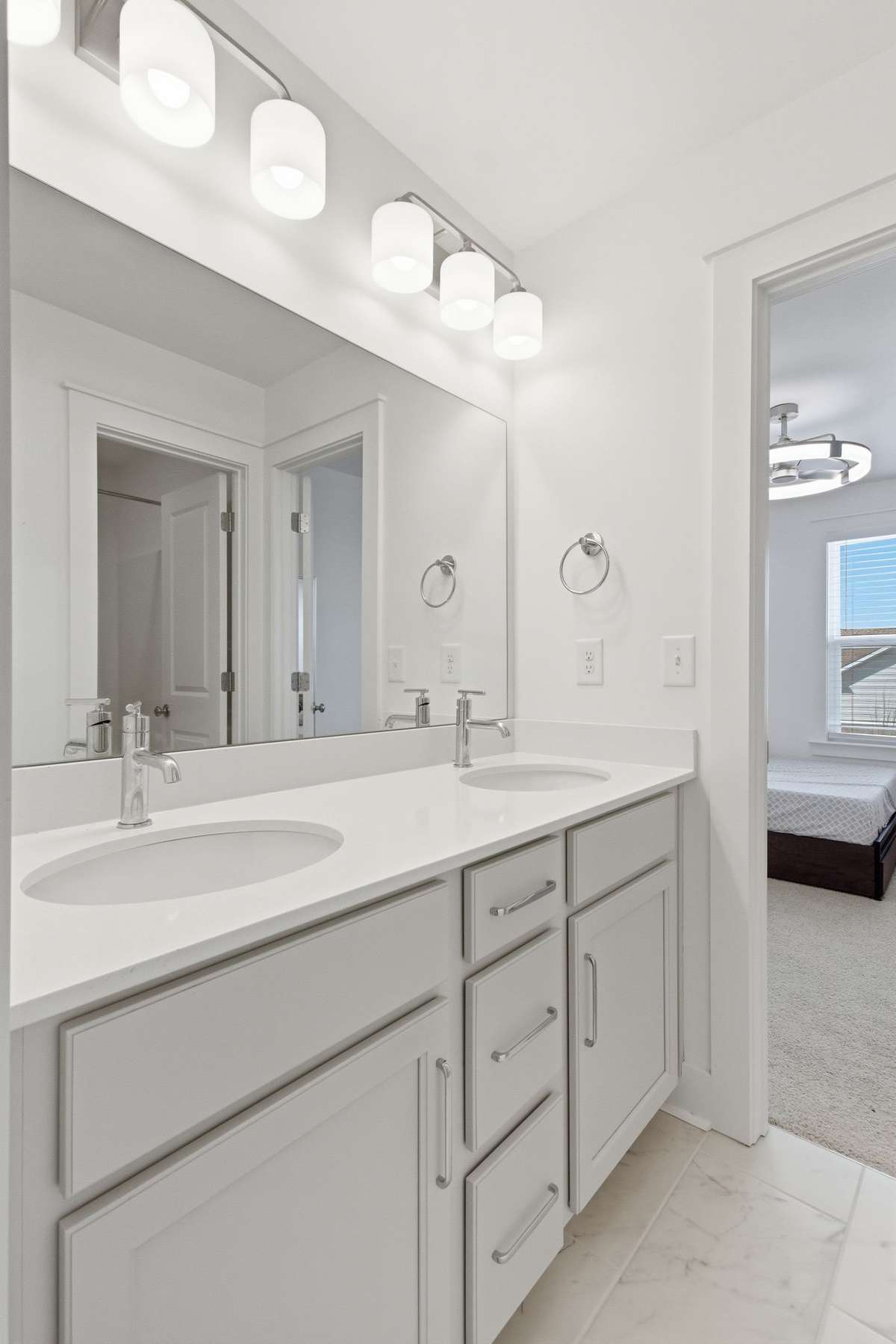 Close-up of the pristine primary bathroom vanity and modern fixtures.