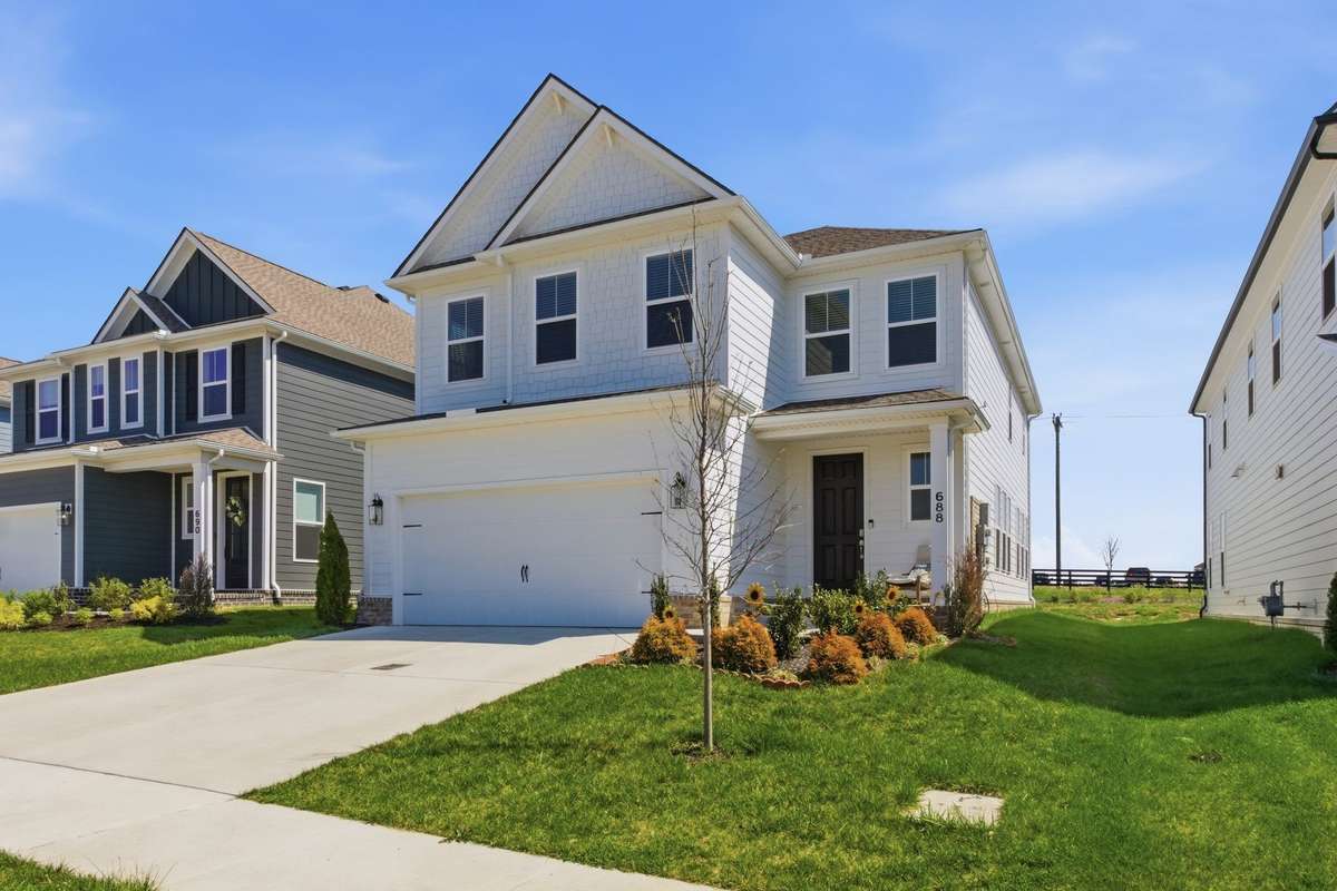 Angled front exterior highlighting the covered porch and crisp landscaping