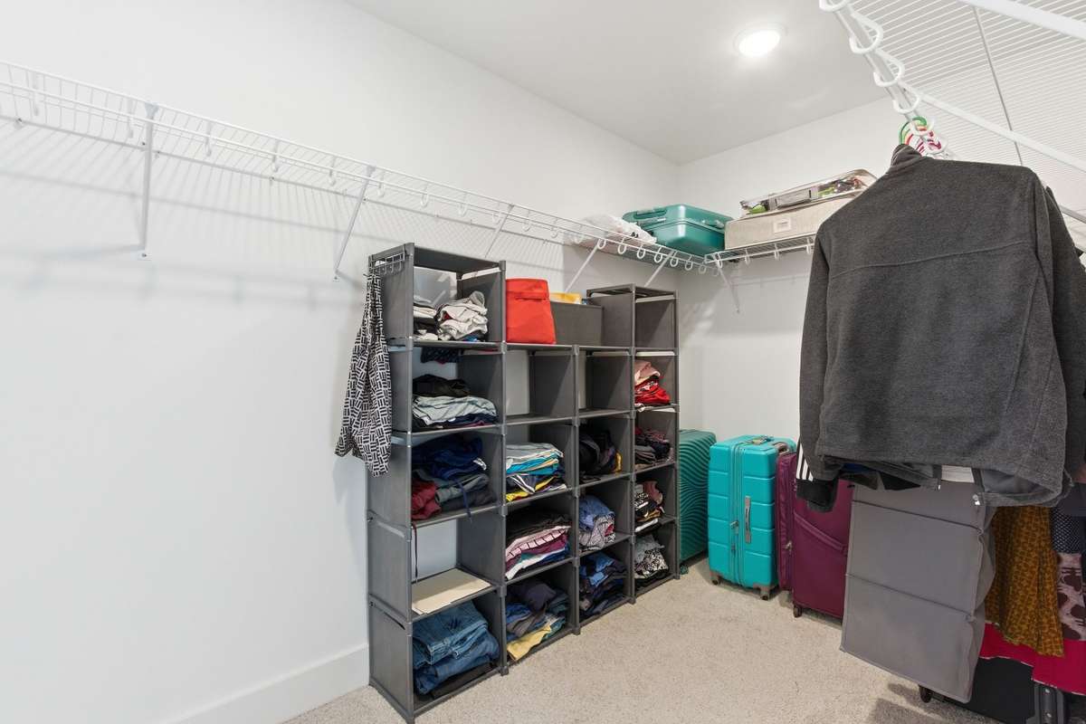 Expansive primary walk-in closet with ample storage potential.