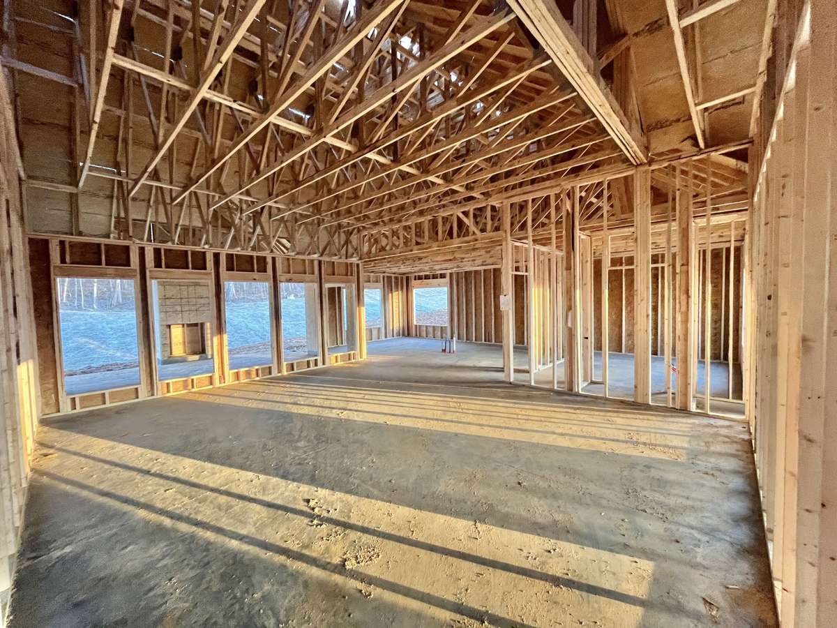 Stock photo From great room entrance looking across to kitchen. Note the 5 extra large windows!