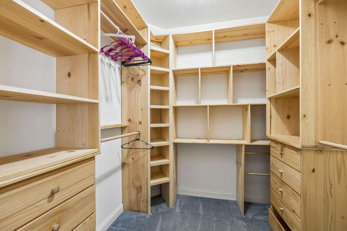 Beautiful custom closet with built-in organizer in the primary bath.