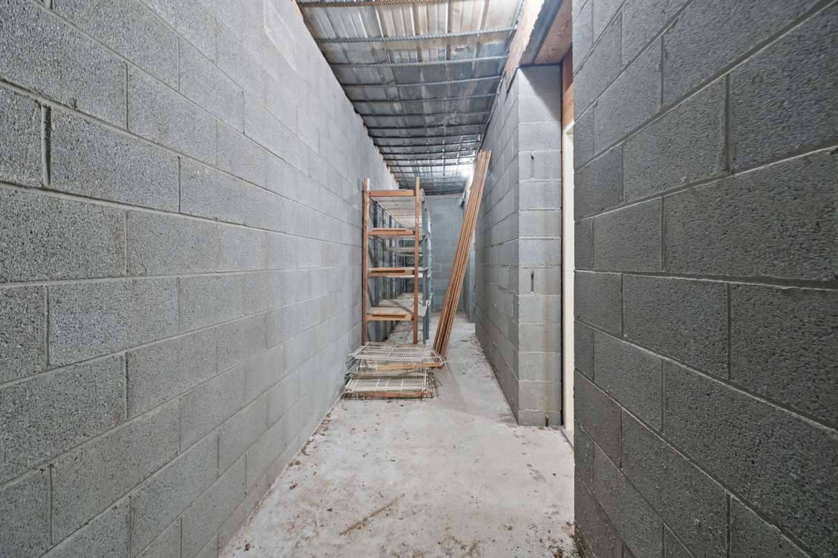 Storm room/storage room under the front porch.  This room was designed to be a storage room/bunker.  The concrete was poured extremely thick for that purpose.