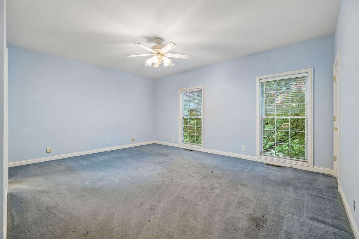 Large primary bedroom with lots of natural light.