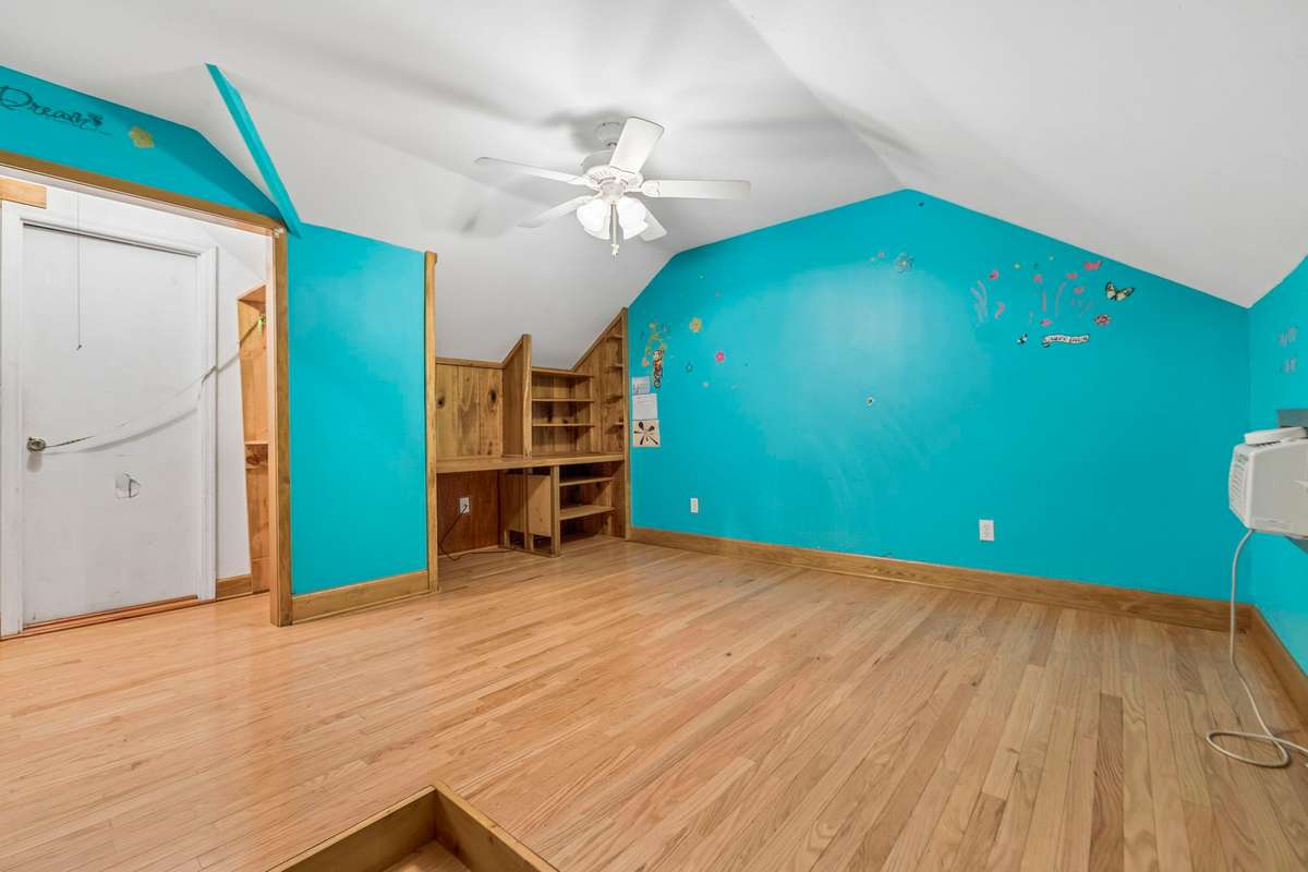 Upstairs office space with large storage closet and built-in desk.