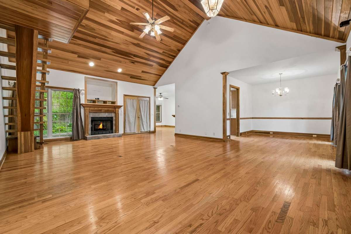 Family Room opens to the formal dining area to the right and the eat-in kitchen to the left.