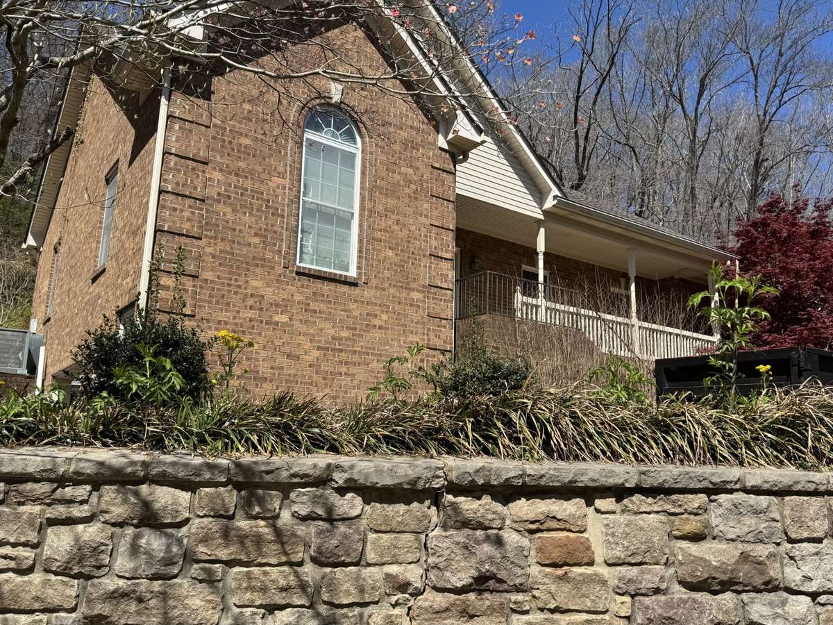 This all brick home sits proudly on Charlotte Pk on 5 wooded acres (unrestricted).  This home was custom built for this hillside lot and takes full advantage of all it offers.