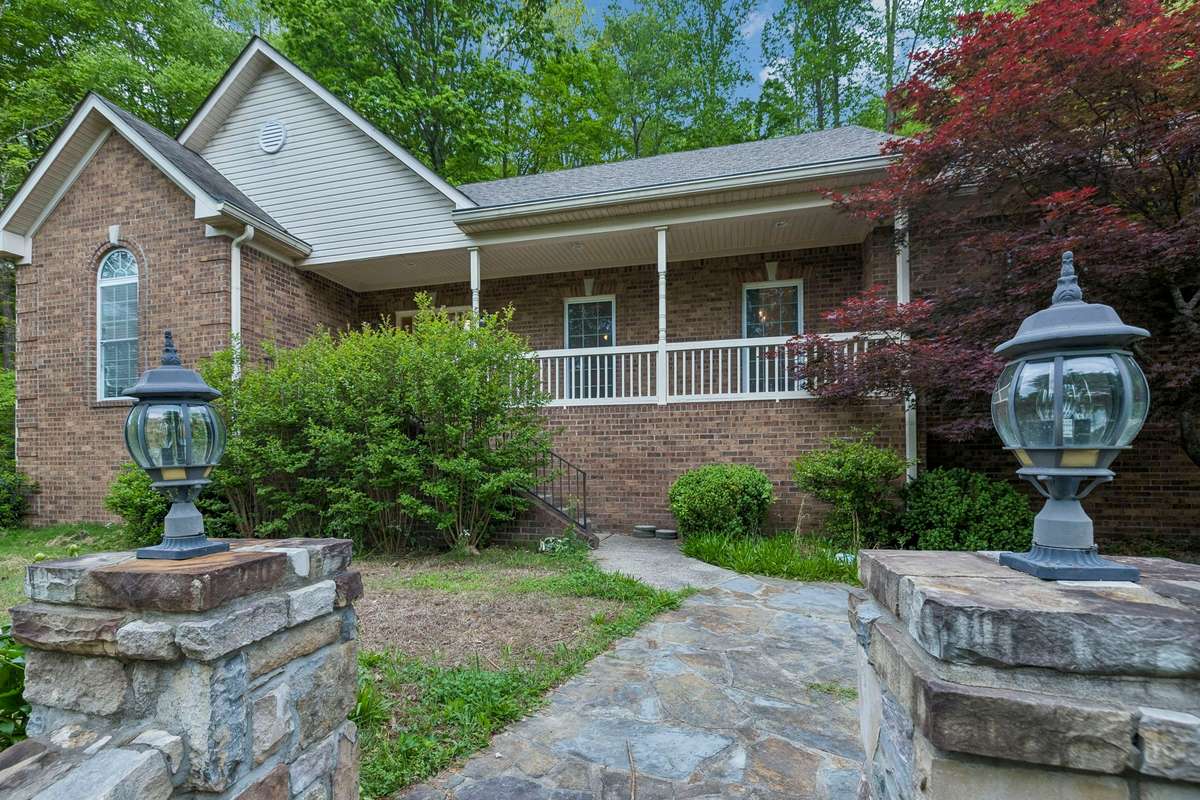 Stone sidewalk leads to the front porch.