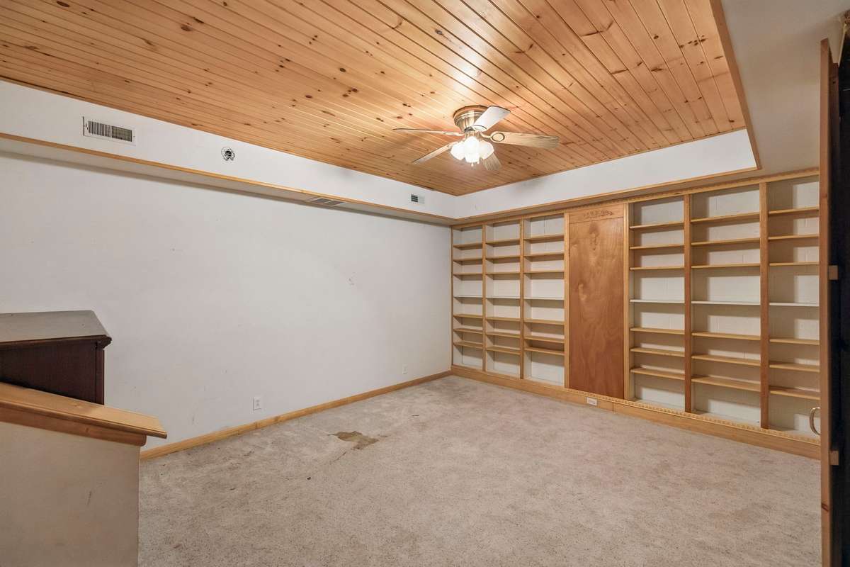One of 3 finished rooms in the basement.  This room was used for collectibles so it has beautiful built in storage shelves.