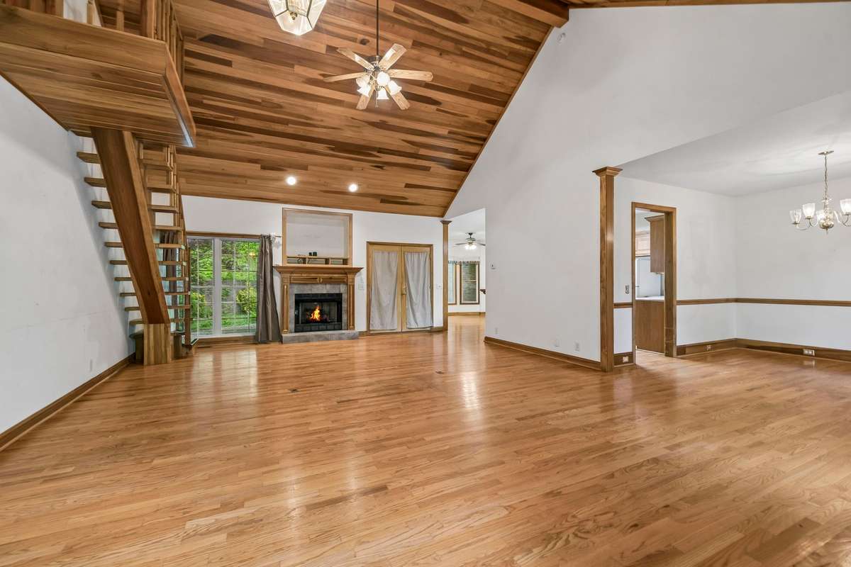 As you come into the home you will see the beautiful poplar tongue-and-groove vaulted ceiling in the family room and a fireplace with gas logs and doors leading to the back patio.