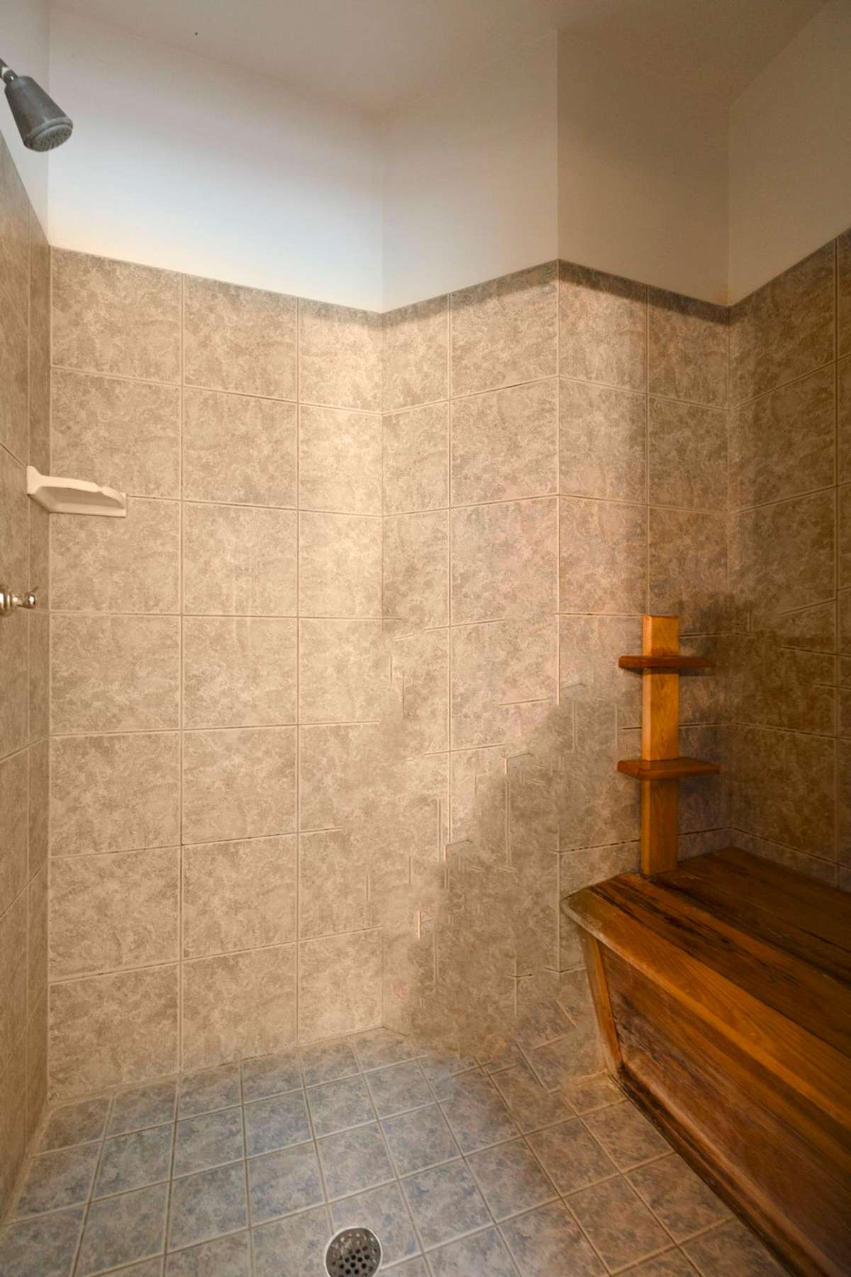 Extra large tile shower with built in bench.