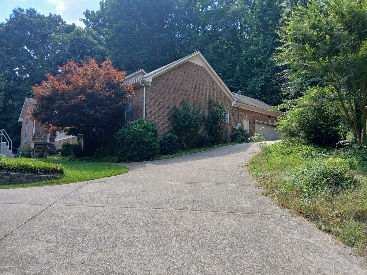 Concrete drive goes up to the 2 car garage and also goes around to the 1 car garage and full basement.