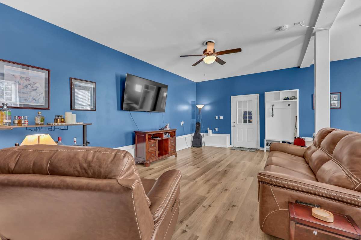 Spacious main floor rec room located at entry from garage to home. There are also man doors adjacent to the garage at front and rear of the home.
