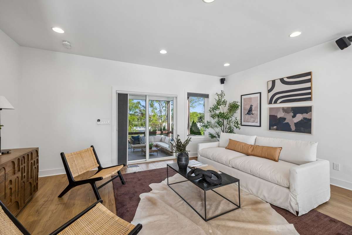 Glass doors brighten up the living room, but custom energy-efficient shades (found throughout the home) let you control the light.