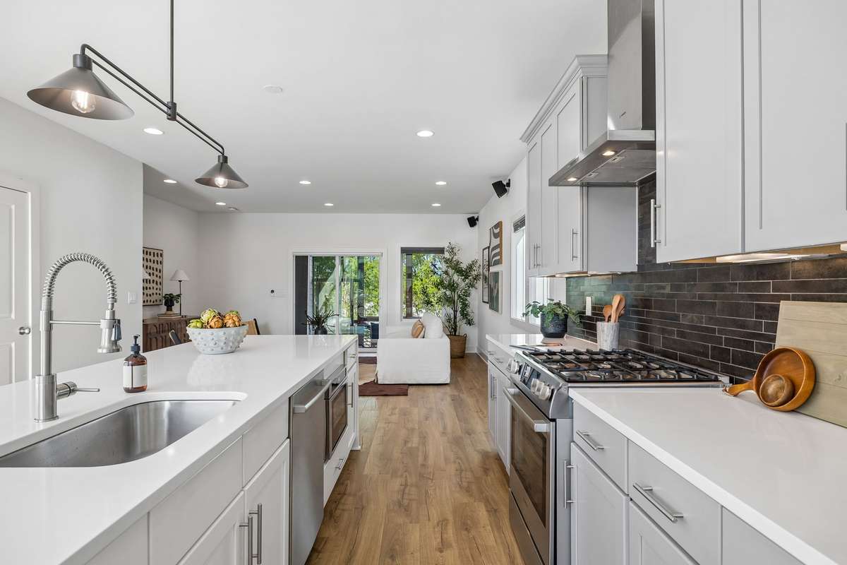 A stylish backsplash frames the shaker cabinets.