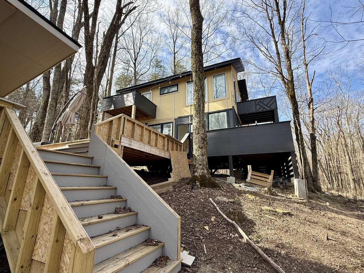 From the deck, a set of well-placed stairs lead your down the front yard, enhancing the flow between indoor and outdoor spaces.