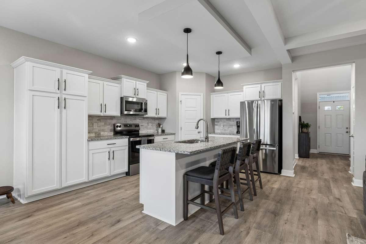 WOW! Awesome cabinet space and a LARGE pantry closet in corner of kitchen. Coffee bar, large island, and stainless steel appliances!
