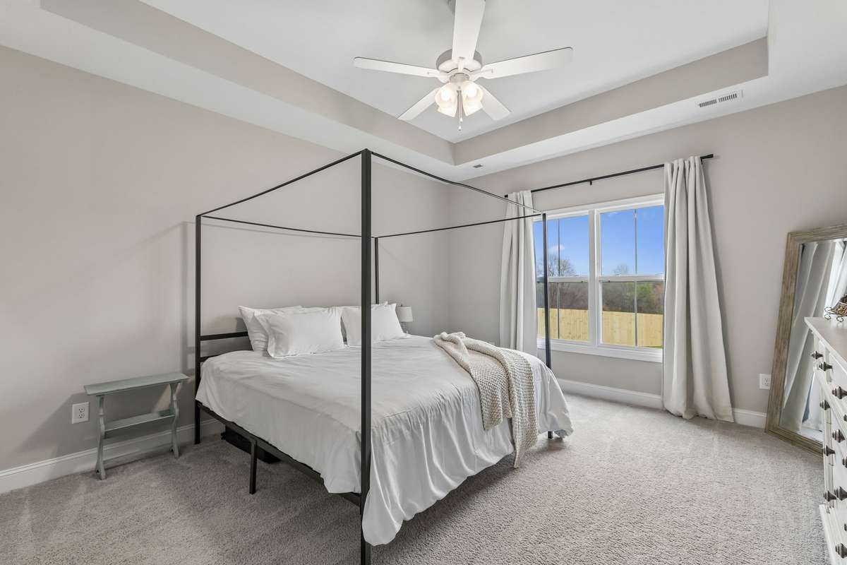 LARGE PRIMARY BEDROOM with awesome window view of back yard.