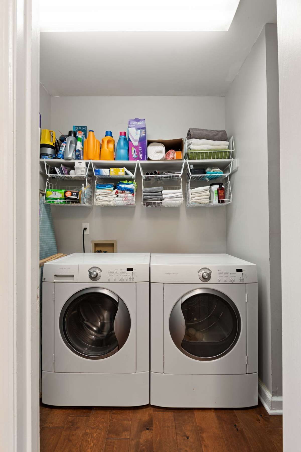A dedicated laundry space with shelving keeps essentials organized and daily routines simple.