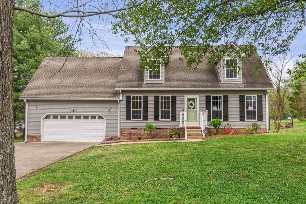 Welcome to 91 Oak Valley, a charming Cape Cod–style home, complete with classic shutters, a welcoming front yard with mature trees, and an attached two-car garage.