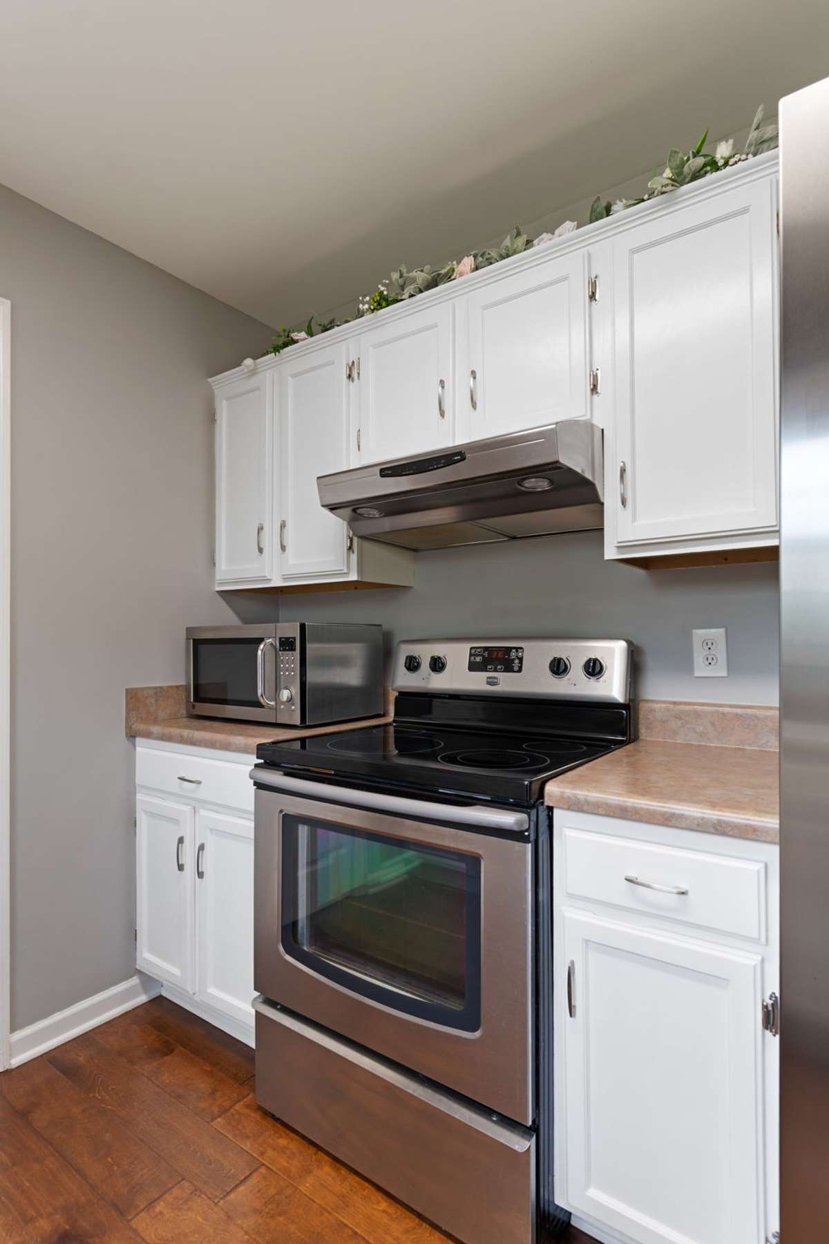 This cozy cooking area features generous cabinetry and counter space, making meal prep simple and efficient.