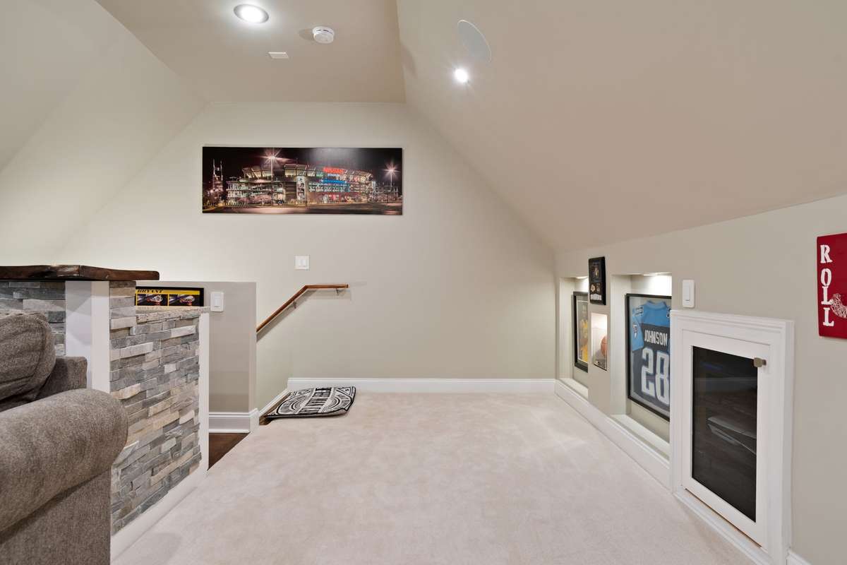 This view highlights the bonus room's easy flow and fun, personalized touches that make it feel like home.