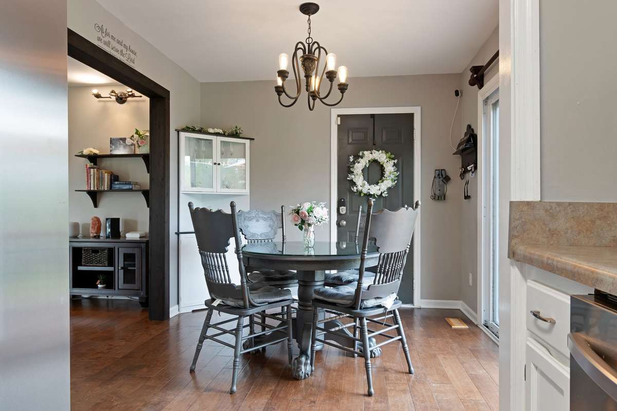 The dining area feels warm and welcoming, with easy access to the kitchen and room to gather with friends and family.